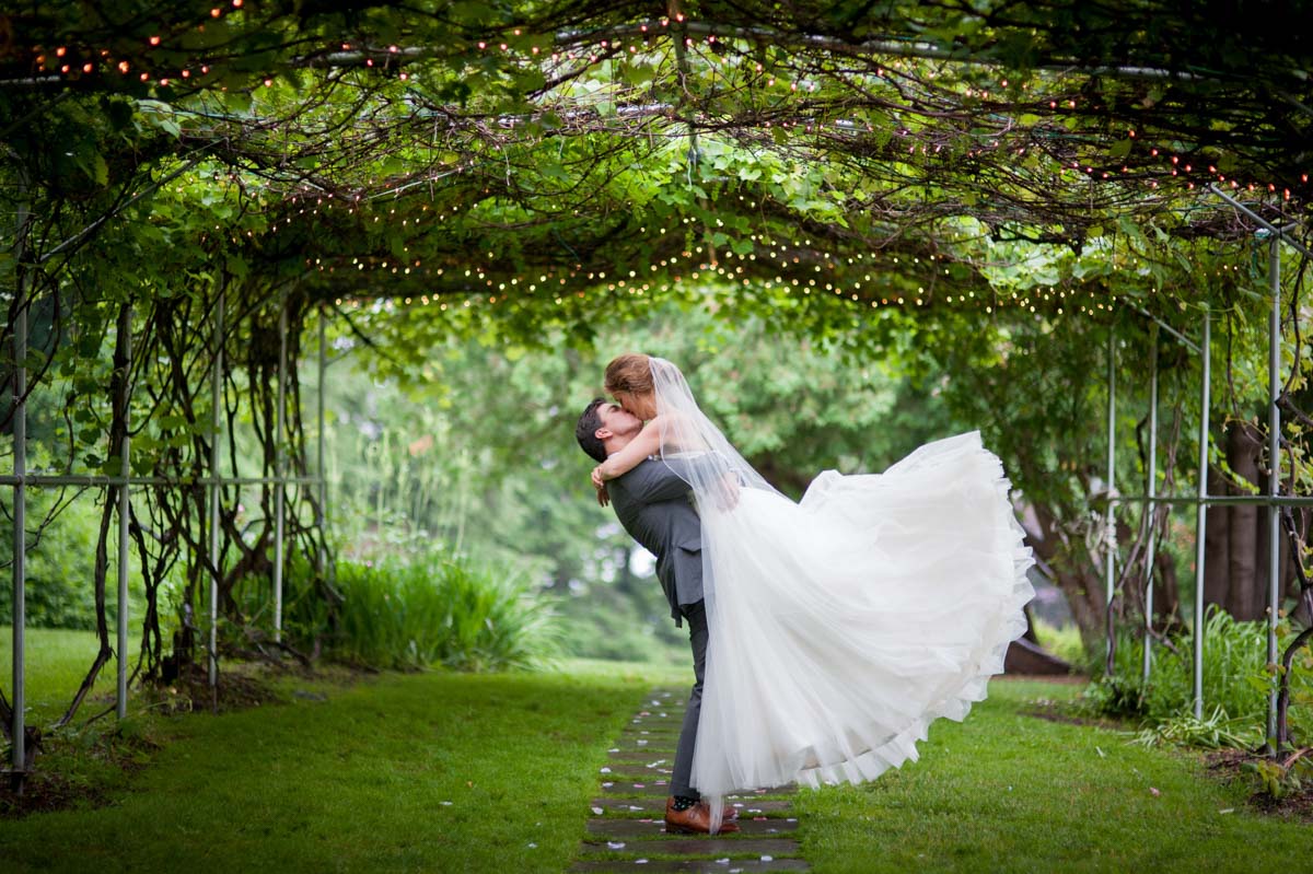 High School Sweethearts Wed high-school-sweethearts-wed-groom-lifting-bride-in-a-kiss