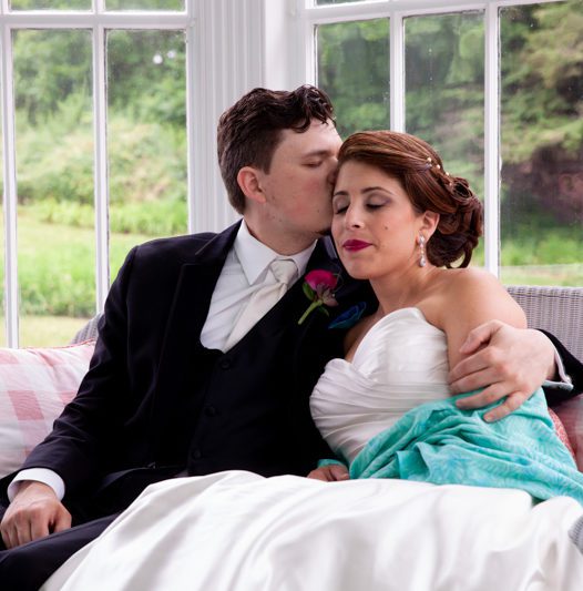 Weddings at Tarrywile Mansion cuban-flair-wedding-robert-rachel-sitting-together-on-glass-in-porch
